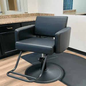 Empty salon chair near mirrors and counter.